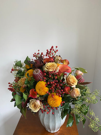 Luxury autumnal bouquet with orange calla lilies, mustard roses and banksia in 70s-inspired design - THE FREE STATE